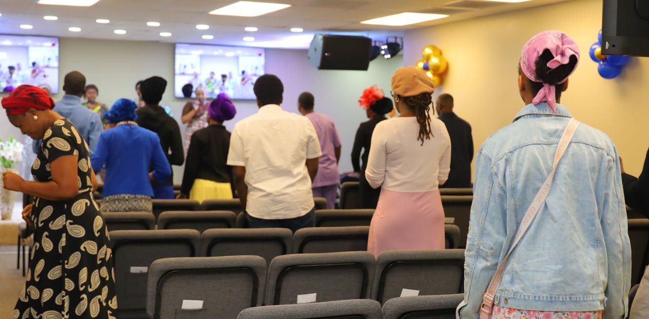 Young adults standing together in service